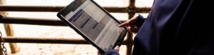 Hands holding a tablet showing MyCHS software on screen