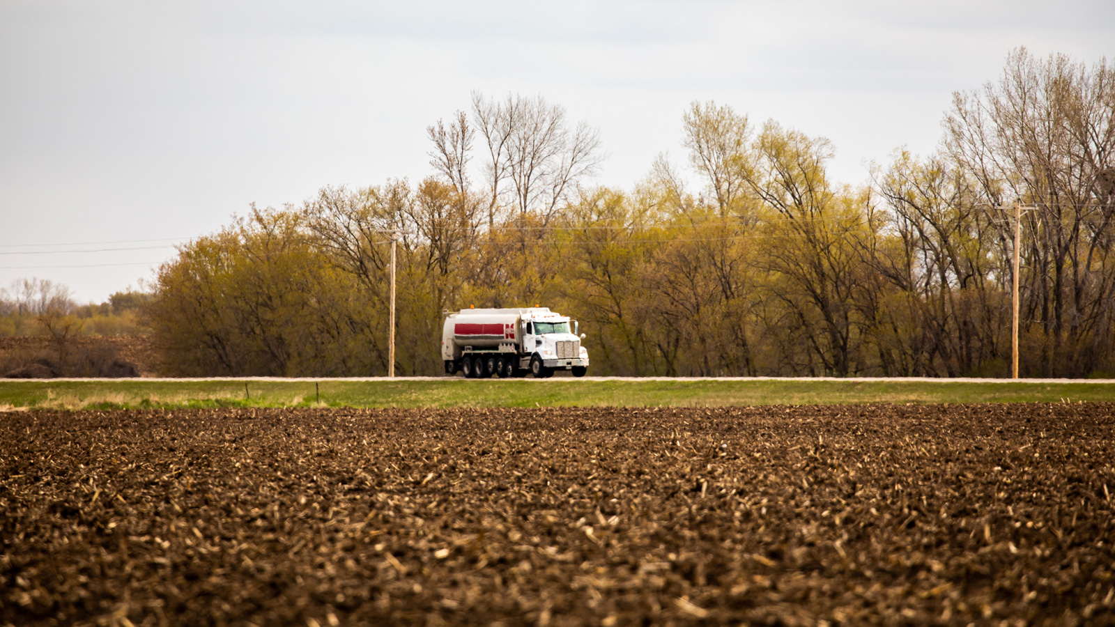 Cenex fuels truck driving down a rural road