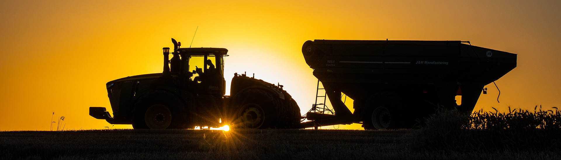 Tractor and gravity box at sunset
